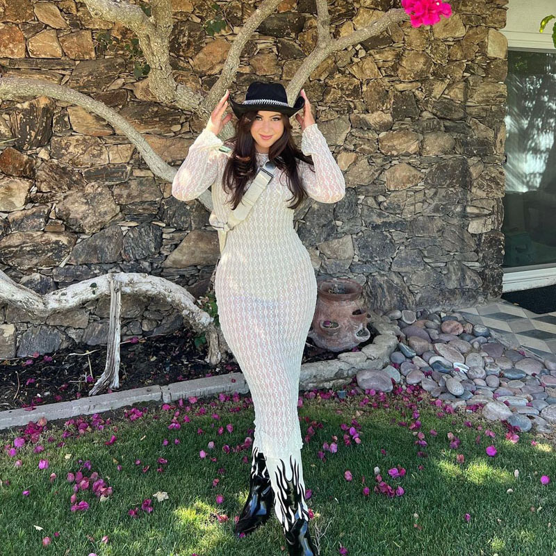 @kendramcleish wearing a black cowboy hat, sheer white dress, and white cowboy boots with black flame details. @kendramcleish wearing a black cowboy hat, sheer white dress, and white cowboy boots with black flame details.