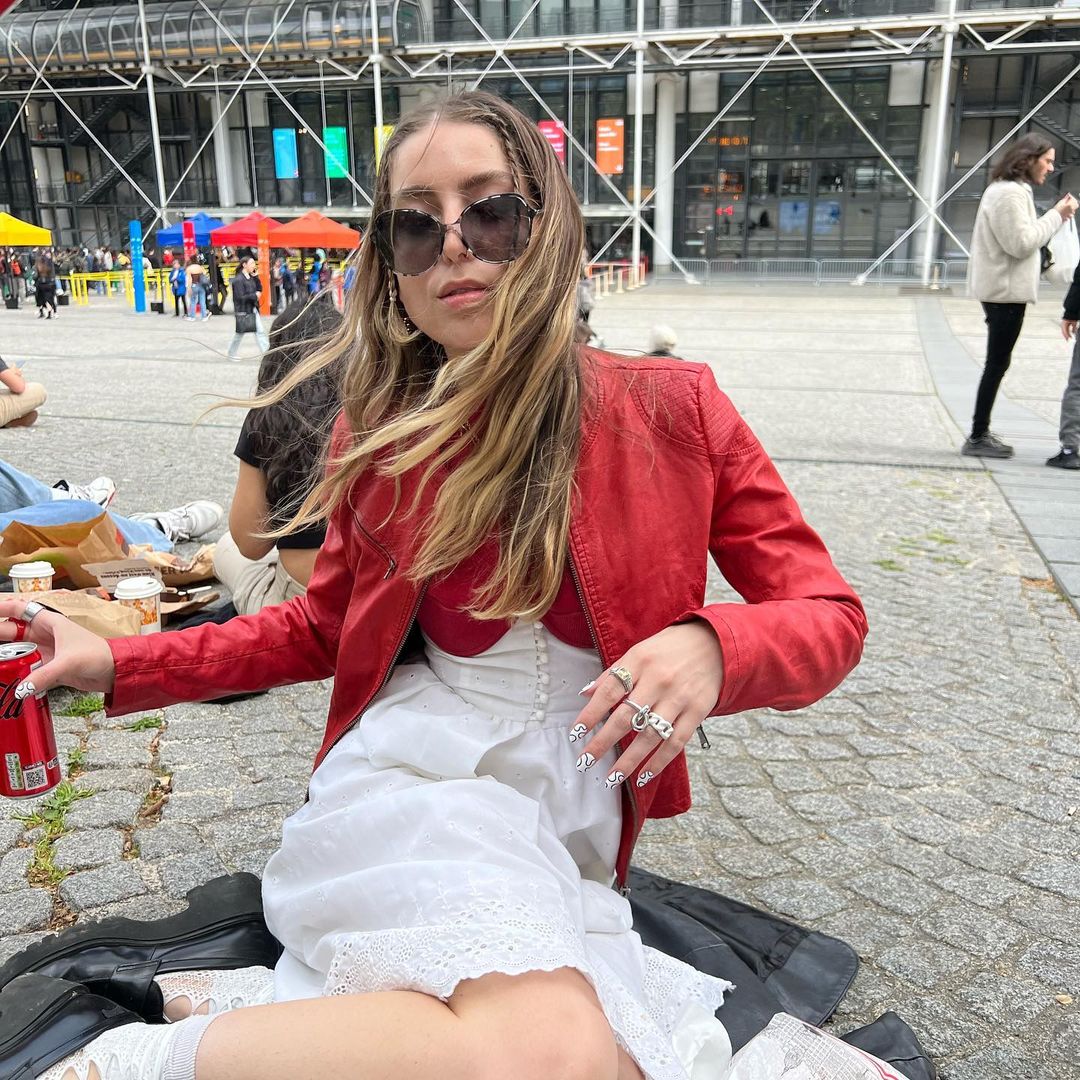 @wantthisnic wearing oversized sunglasses, a red leather moto jacket, and a red dress with a white eyelet corset and skirt. @wantthisnic wearing oversized sunglasses, a red leather moto jacket, and a red dress with a white eyelet corset and skirt.