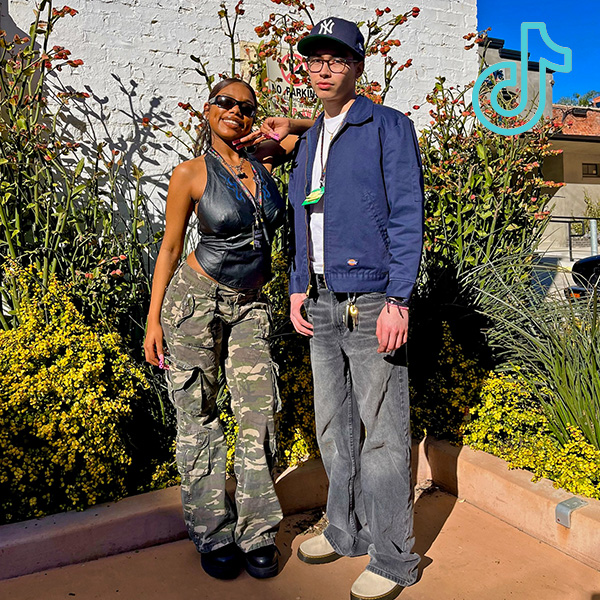 tt 3 2 people standing in front of plants wearing spring outfits