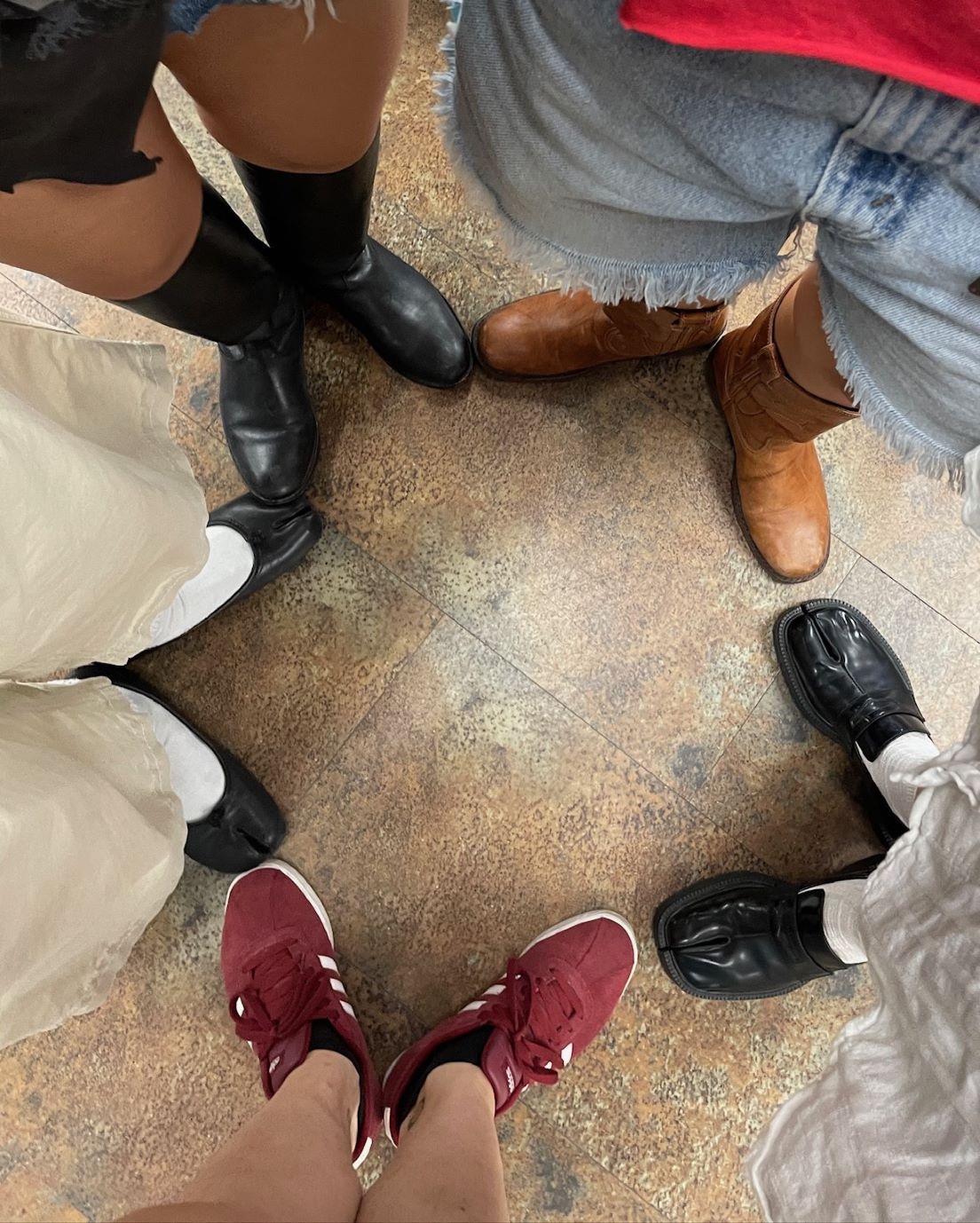 Buffalo Exchange employees making a star shape with their shoes