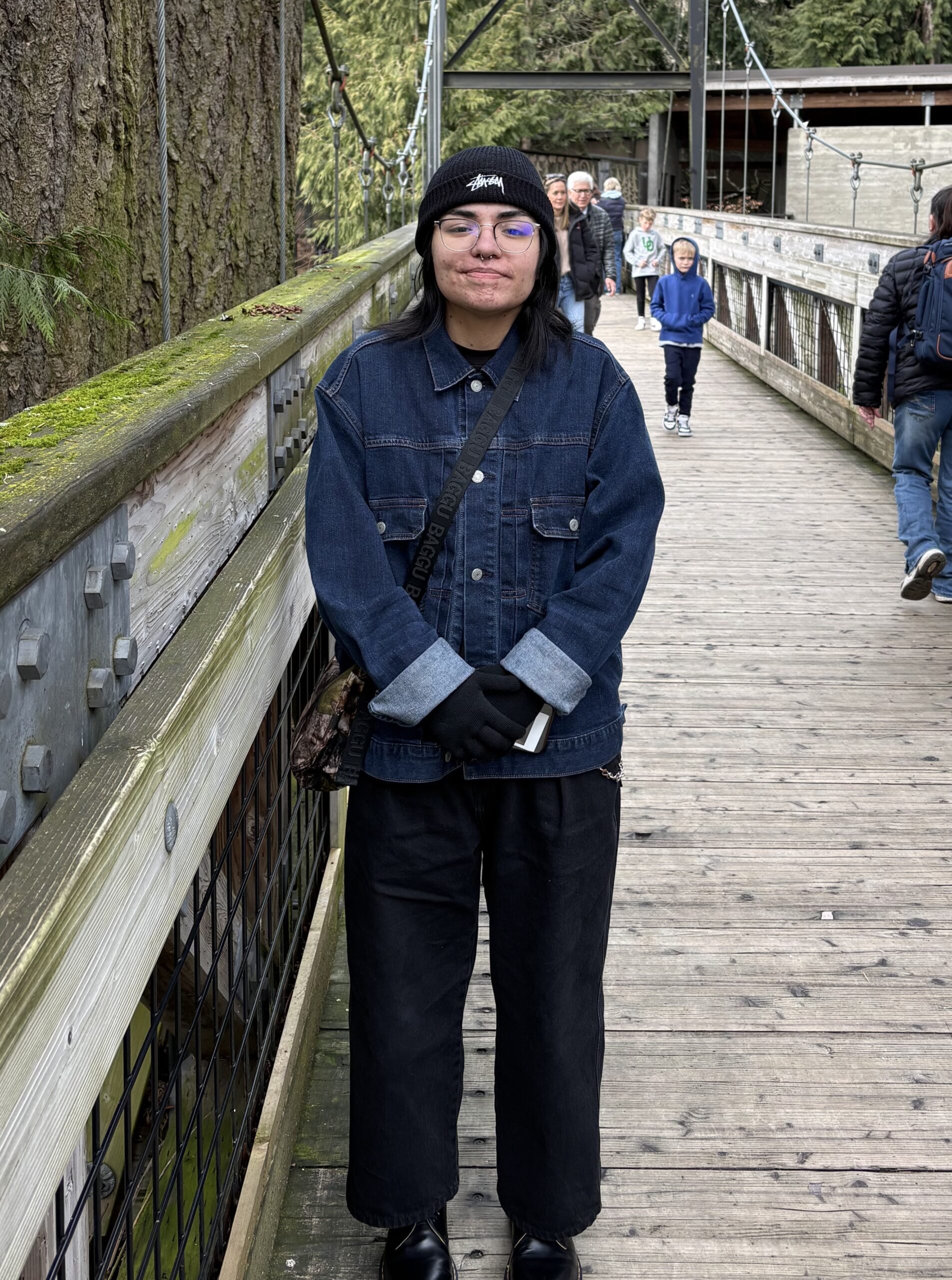 Employee Krystal standing on bridge in nature